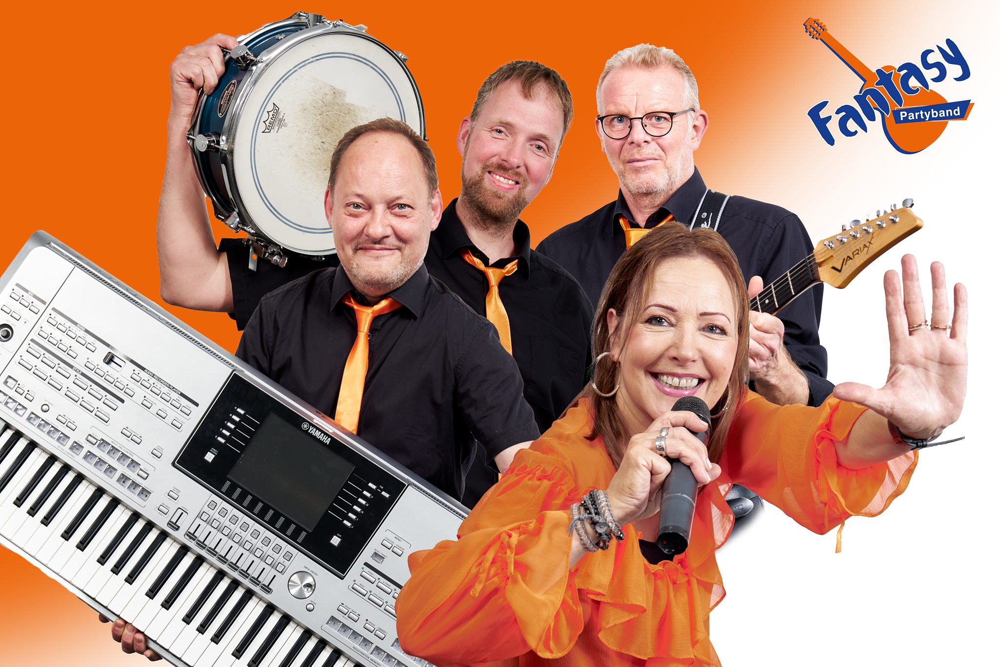 Vier Mitglieder der Fantasy Partyband mit Instrumenten, eine Frau mit Mikrofon und winkend.